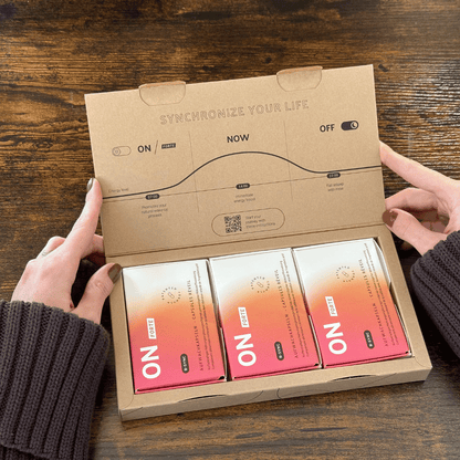 Cardboard packaging with gradient product boxes on a wooden surface